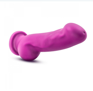 Avant Ergo realistic silicone purple dildo with balls and suction cup base lying on side on white background 