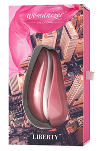 Packaging for the Pink Womanizer LIberty rechargeable air pressure vibrator sex toy with removable silicone cap and storage lid. Usb rechargeable and fully waterproof 