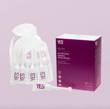 Load image into Gallery viewer, A drawstring pouch containing lots of 5ml applicators of Yes VM vaginal moisturiser next to an example of the purple cardboard box that it comes in.