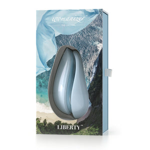 Packaging for the Breezy Blue Womanizer LIberty rechargeable air pressure vibrator sex toy with removable silicone cap and storage lid. Usb rechargeable and fully waterproof - Sex Siopa Ireland