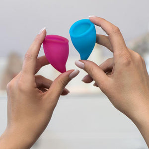 Hands holding the Fun Factory silicone reusable menstrual cups - Sex Siopa, Ireland's best online sex toy shop
