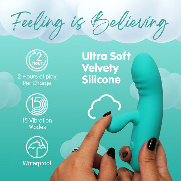 Packaging of the Skins touch rabbit vibrating sex toy in teal, featuring a picture of it being held up against a teal background, with a finger pulling back on the flexible clitoral stimulator, as well as additional information.