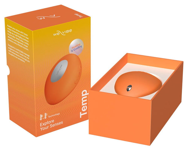 An orange teardrop-shaped personal massager shown next to its orange retail box, with the box lid open to reveal the product inside on a white background.