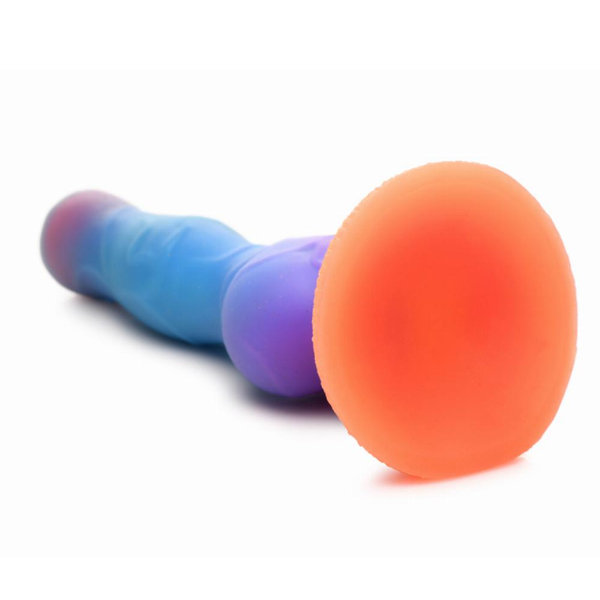 A view from below of the horizontal silicon textured alien dildo in orange/purple/blue colour scheme. Close up of the suction base in orange.
