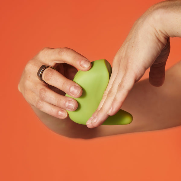 A woman demonstrates with her hands how the Kiwi pelvic health vibrator can be used for shallow penetration