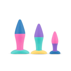 3 sizes of multicoloured butt plugs standing in a line from largest to smallest