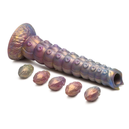 Creature cocks tentacle ovipositor laid out lengthwise alongside its 5 silicone larval eggs
