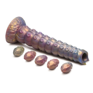 Creature cocks tentacle ovipositor laid out lengthwise alongside its 5 silicone larval eggs
