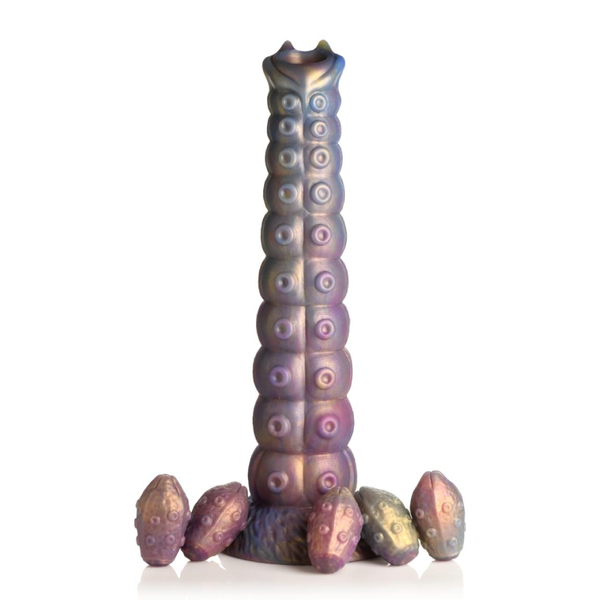 The Creature Cocks tentacle ovipositor dildo standing up on it's suction cup base surrounded by 5 silicone eggs.