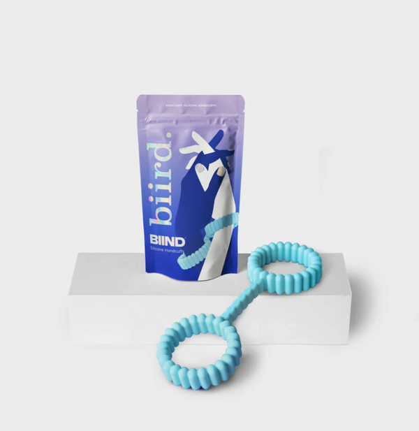 Biird Cuffi silicone handcuffs and plastic packaging in front of a white background