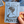 Hand holding a blue education zine about Monto, by the artist Selkies. Over a brown table background and other zines.