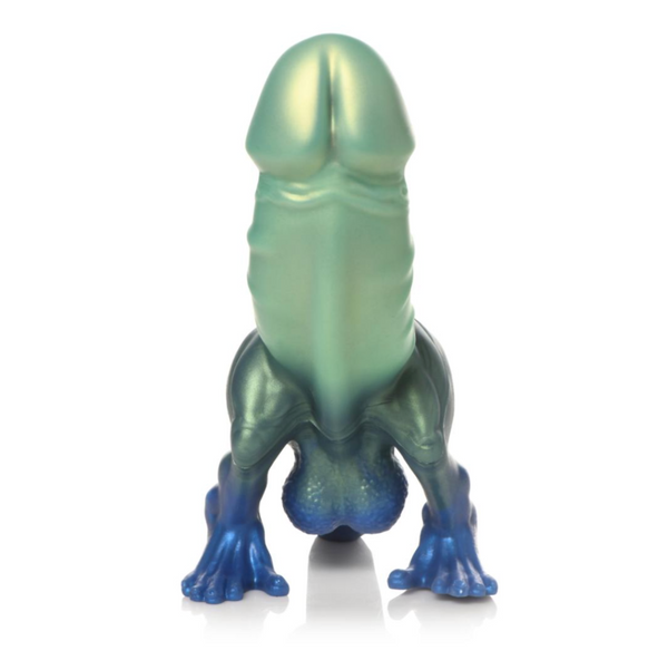 A novelty figurine shaped like a stylized penis in a crouching frog-like pose, with a metallic iridescent finish shifting from pale green at the top to blue at the feet, photographed on a clean white background.