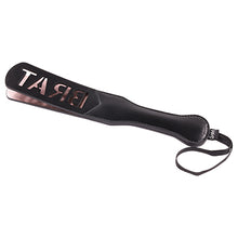 Load image into Gallery viewer, Sportsheets brat impression spanking paddle lying on its side with the flap of the paddle with BRAT imprinted facing up - Sex Siopa stocks Ireland&#39;s best sex toys, lubricants and accessories. 