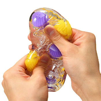 Hands holding up a multicoloured Tenga Bobble Masturbation Sleeve..