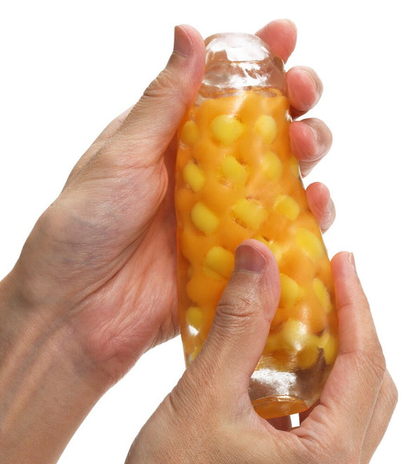 Two hands holding up a Tenga Arte Weave, yellow/orange theme.
