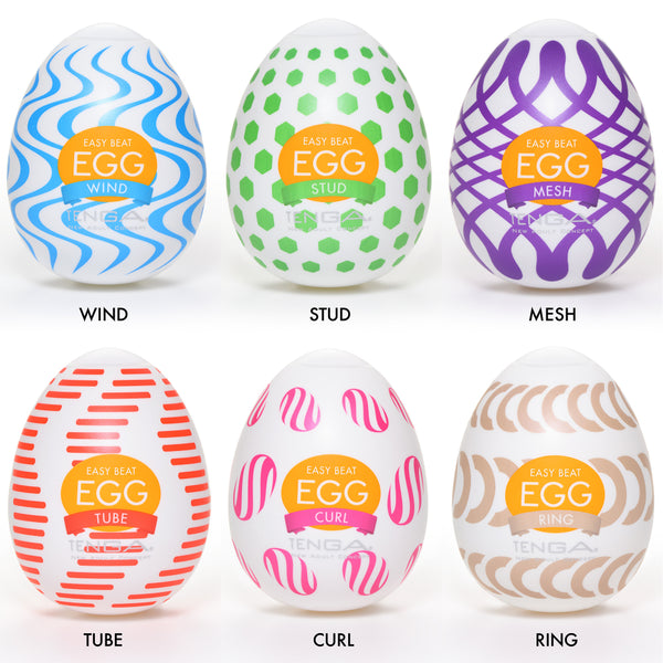 Tenga egg crate selection of masturbation sleeves on a white background, with multicoloured varied packaging.