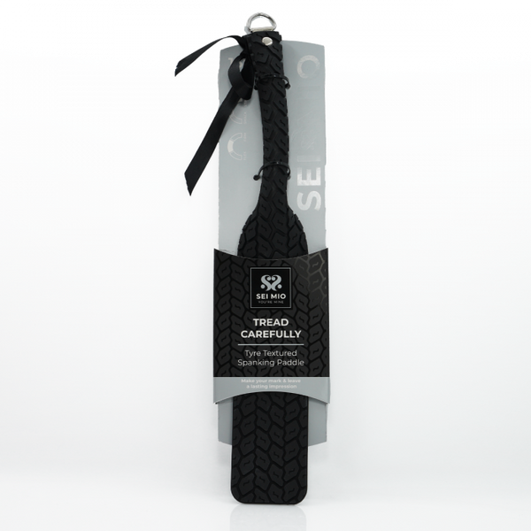 Tyre Tread Spanking Paddle in packaging with ribbon tied to hanger and clear flexible tyre marked paddle - Sex Siopa stocks Ireland's best sex toys, lubricants and accessories. 