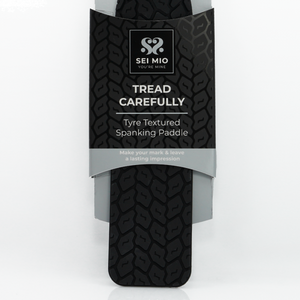Zoomed image of the tyre tread spanking paddle in its packaging with description text tyre textured spanking paddle - Sex Siopa stocks Ireland's best sex toys, lubricants and accessories