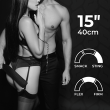 Load image into Gallery viewer, Man and woman standing side by side in alluring lingerie with handcuffs and man holding the paddle to the woman&#39;s bum with description of paddle characteristics - Sex Siopa stocks Ireland&#39;s best sex toys, lubricants and accessories