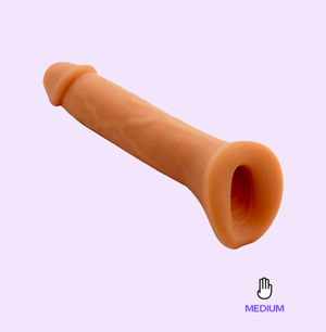 The Wet for her pack n play dildo floats over a lavender background showing it's subtle veins and textured stroker base