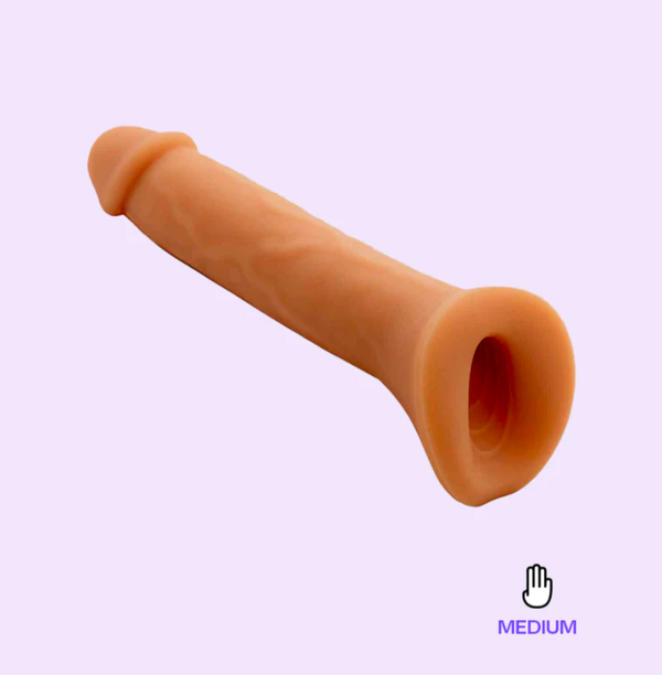 The Wet for her pack n play dildo floats over a lavender background showing it's subtle veins and textured stroker base