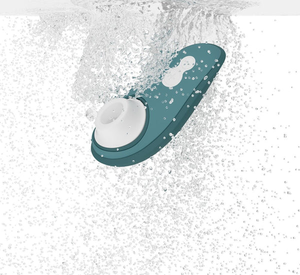 Illustration of the Womanizer Liberty 2 Rechargeable "Sucking" Vibrator in shades of green and white under many droplets of water. 