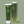 A 140ml bottle of Yes OB plant oil based lubricant next to an example of its green cardboard packaging, on a light green wavy background.