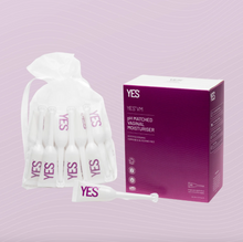 Load image into Gallery viewer, A drawstring pouch containing lots of 5ml applicators of Yes VM vaginal moisturiser next to an example of the purple cardboard box that it comes in. 