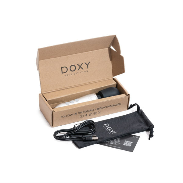 Doxy Go rechargeable wand vibrator in a brown branded box alongside a charging cable and black bag, all in front of a white background 