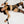 Female model lying on white bed sheets being restrained by the Sei Mio Bed-Spreader Under Bed Restraint System in black.