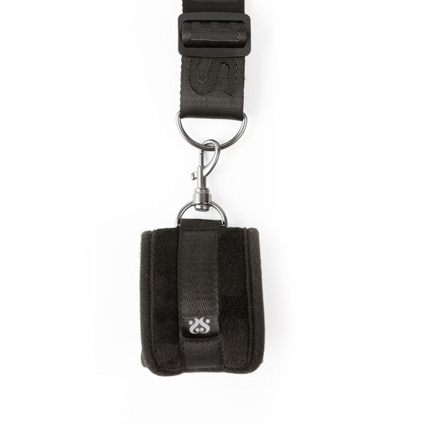 Close up of the cuff and strap of the SEI MIO - Doorway Control Play - Adjustable Over Door Cuff Restraints laid out on a white background