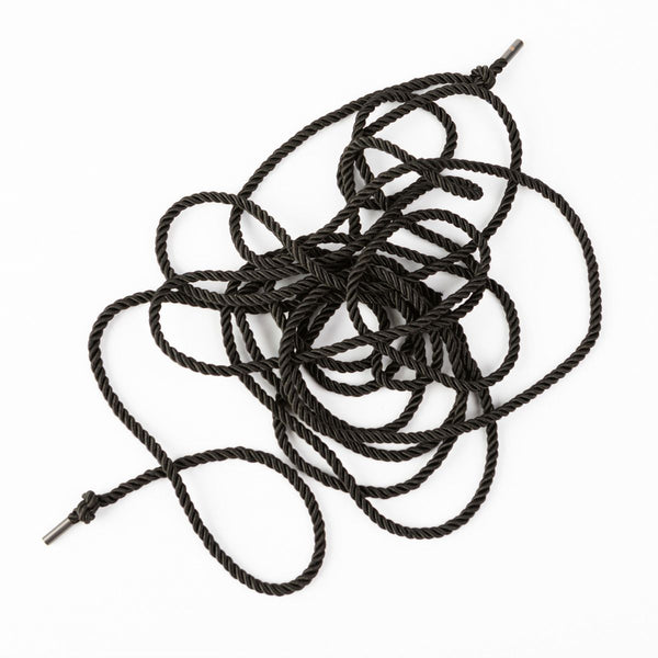 Messy picture of SEI MIO - Knot in Control - 10m Silky Bondage Rope in black on a white background.