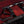 Close up of the strap and bar components of the SEI MIO - Behind Closed Doors - Adjustable Door Hanging Sex Swing in black on a red crushed velvet background