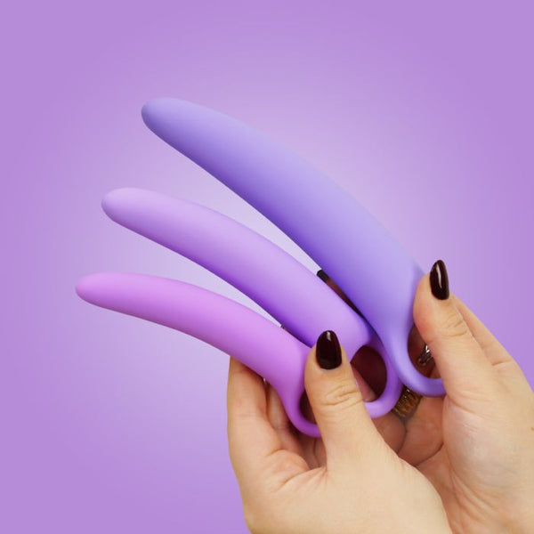 Woman's hands holding sizes 1-3 of the Skins Care silicone dilator set against a purple background.
