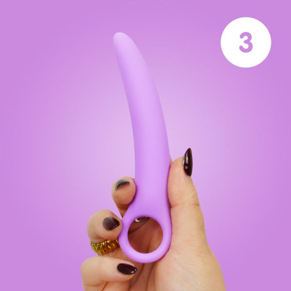 Woman's hand holding size 3 of the Skins Care silicone dilator set against a lilac background.