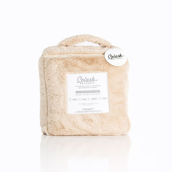 Image shows a cream coloured waterproof faux fur splash blanket folded up into it's carrying case against a white background.