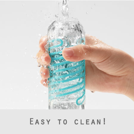 Hand cleaning the Tenga Spinner, a masturbator sex toy for men. Clear toy with turquoise swirls, with water dripping on a white background - Sex Siopa Ireland's favourite adult shop