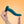 Picture of female hands holding the Fun Factory Limba Flex silicone dildo with suction base for a strap-on harness. Coloured in dark green this is set on a light orange background. The Limba Flex comes in a small and medium size. Available at SexSiopa.ie, Ireland's favourite sex toy retailer.