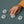 Picture of a hand with a yellow sleeve playing with some white unstacked Ohnut silicone intimacy bumpers. Scene set on a grey background. The Ohnut tool is for more comfortable sex for people who have endometriosis - Sex Siopa Ireland