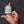 Hand with finger holding a stack of Ohnut silicone bumpers that help prevent pain during sex for people with endometriosis. Shown on a textured fabric background - Sex Siopa Ireland