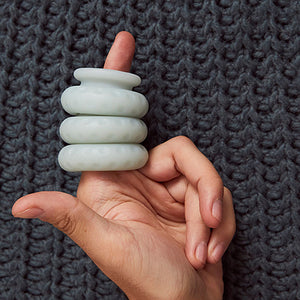 Hand holding a stack of Ohnut silicone bumpers that help prevent pain during sex for people with endometriosis - Sex Siopa Ireland