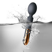 Load image into Gallery viewer, Rocks Off Oriel rechargeable wand vibrating splashing in water to show that it is 100% waterproof. Sex Siopa, Ireland&#39;s Best Sex Toys!