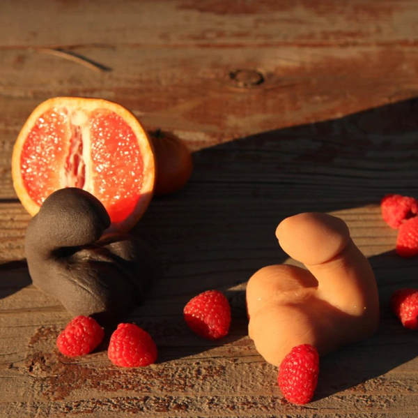 Size comparison image of the Tantus On the Go Packer in Cocoa and Mocha alongside raspberries and a grapefruit - Sex Siopa, Ireland's best adult shop.