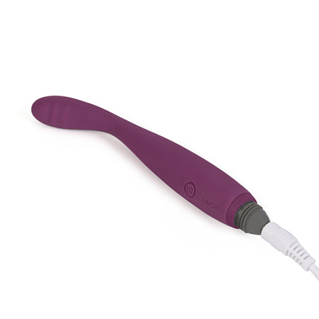 Picture of the Svakom Cici in a burgundy colour scheme plugged into a white cable on a white background. The Svakom Cici rechargeable silicone vibrator sold by Sex Siopa, Ireland's best sex toy shop in Dublin