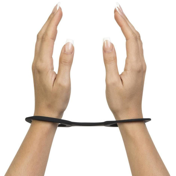 Hand model wearing Quickie Cuffs silicone BDSM restraints in black - Sex Siopa, Ireland's Best Sex Toys
