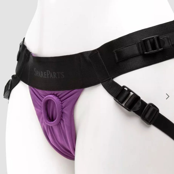Spareparts Joque strapon harness with 2 fully adjustable straps and flexible O-ring in black with a purple crotch, shown on a white mannequin. The Joque Harness is made from breathable, moisture wicking poly spandex and is machine washable. Dildos and other sex toys sold seperately. - Sex Siopa Ireland